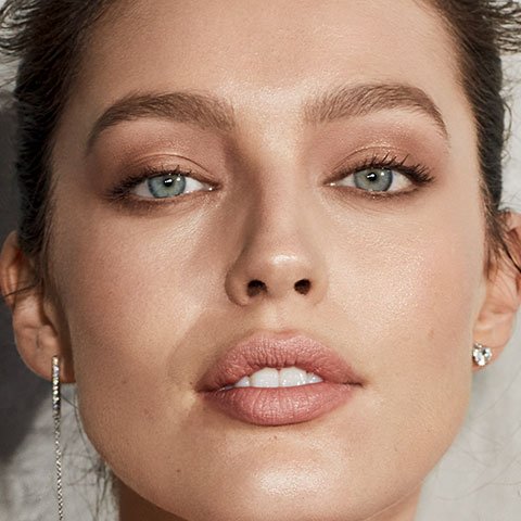 Close up of model woman wearing glowy makeup look